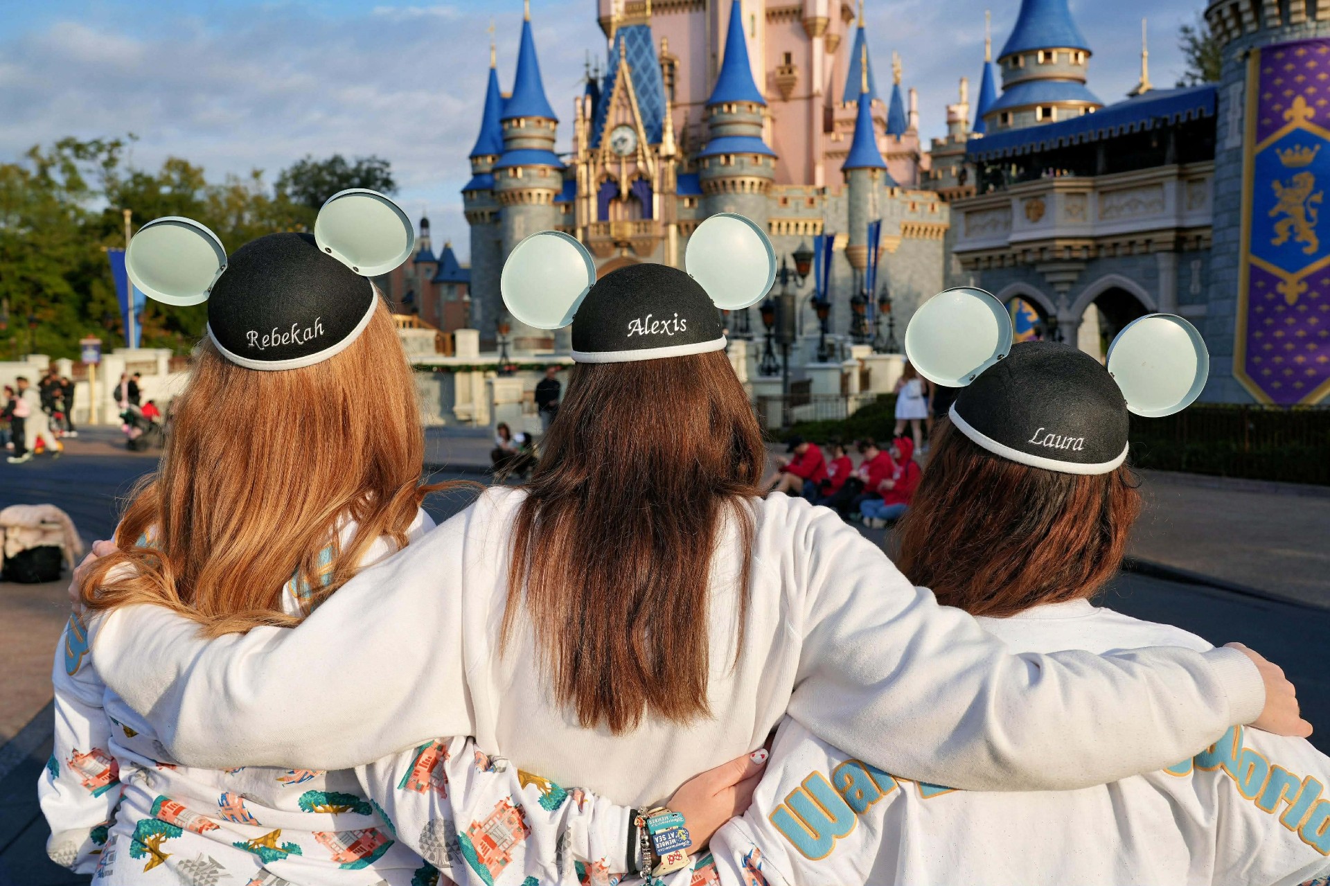 Rebekah, Alexis and Laura wearing Mickey ears in front of Cinderella Castle at Walt Disney World