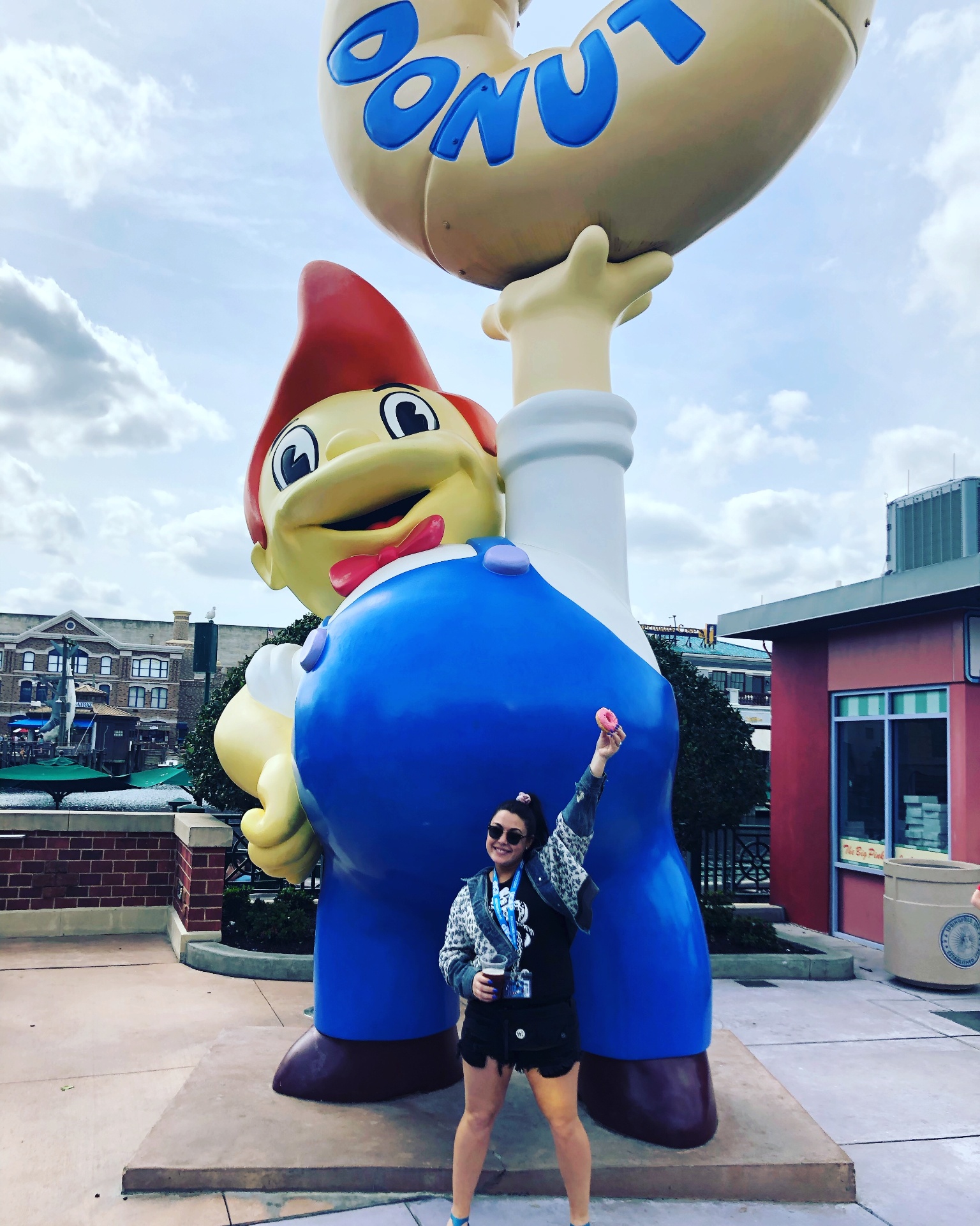 Giselle at the Lard Lad Donuts statue in Universal Orlando's Springfield