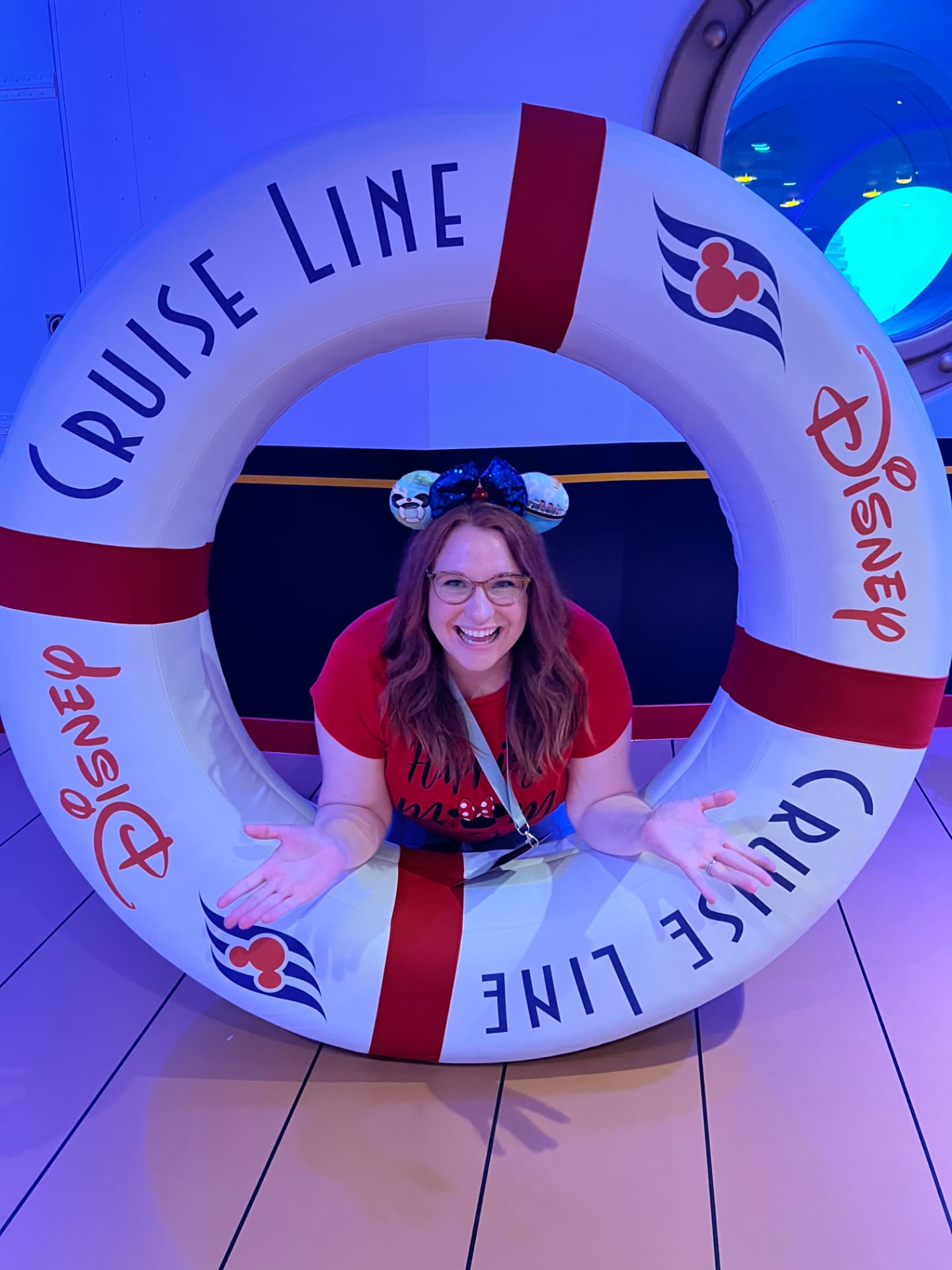 Jamie Thomas posing inside a Disney Cruise Line life ring