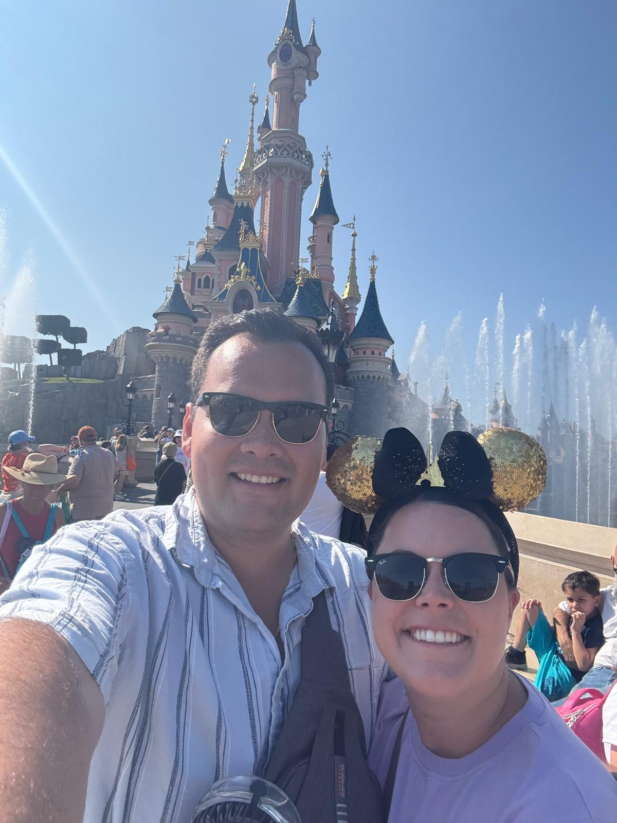 Manuel Suarez Delgado and his wife in front of Sleeping Beauty Castle at Disneyland Paris