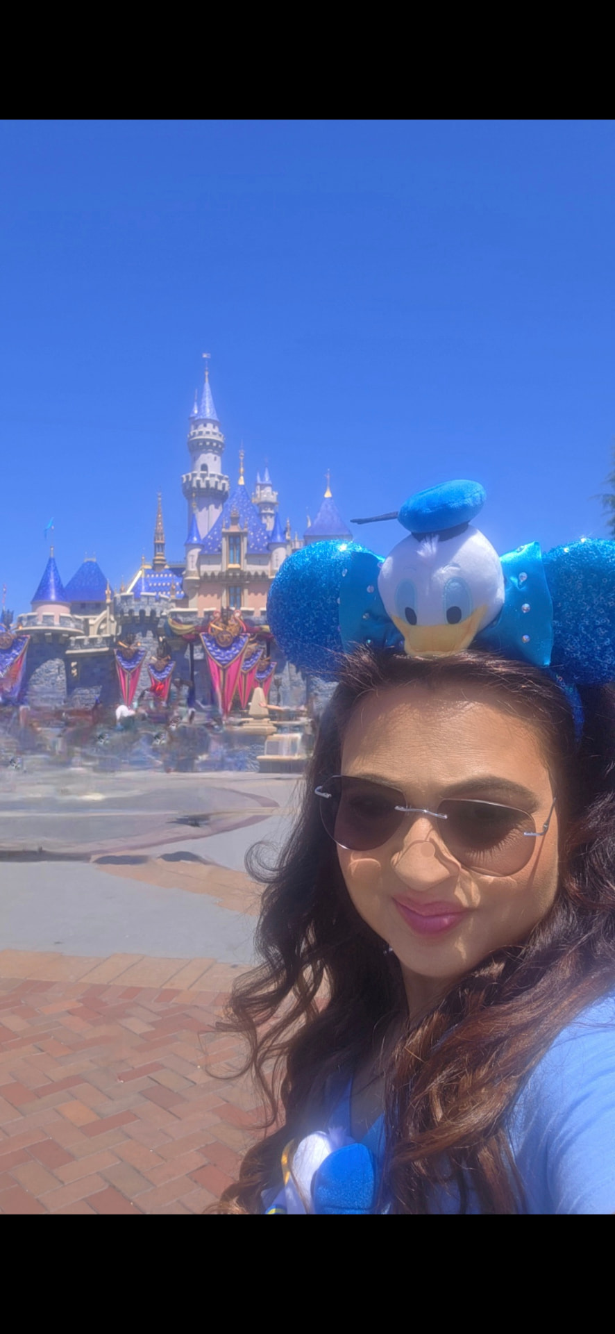 Farya Zubair in front of Sleeping Beauty Castle during Disneyland's 70th celebration