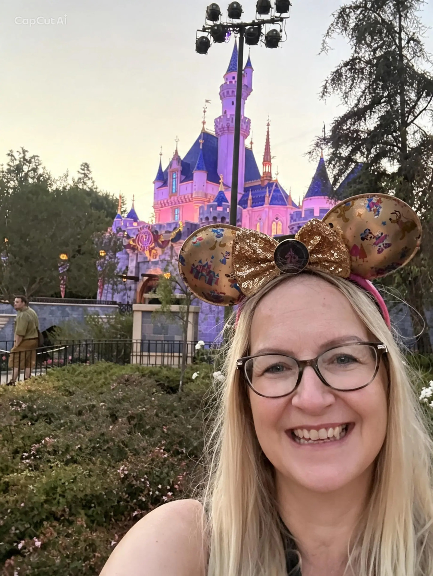 Teresa Mazzotta at Disneyland in front of Sleeping Beauty Castle at sunset