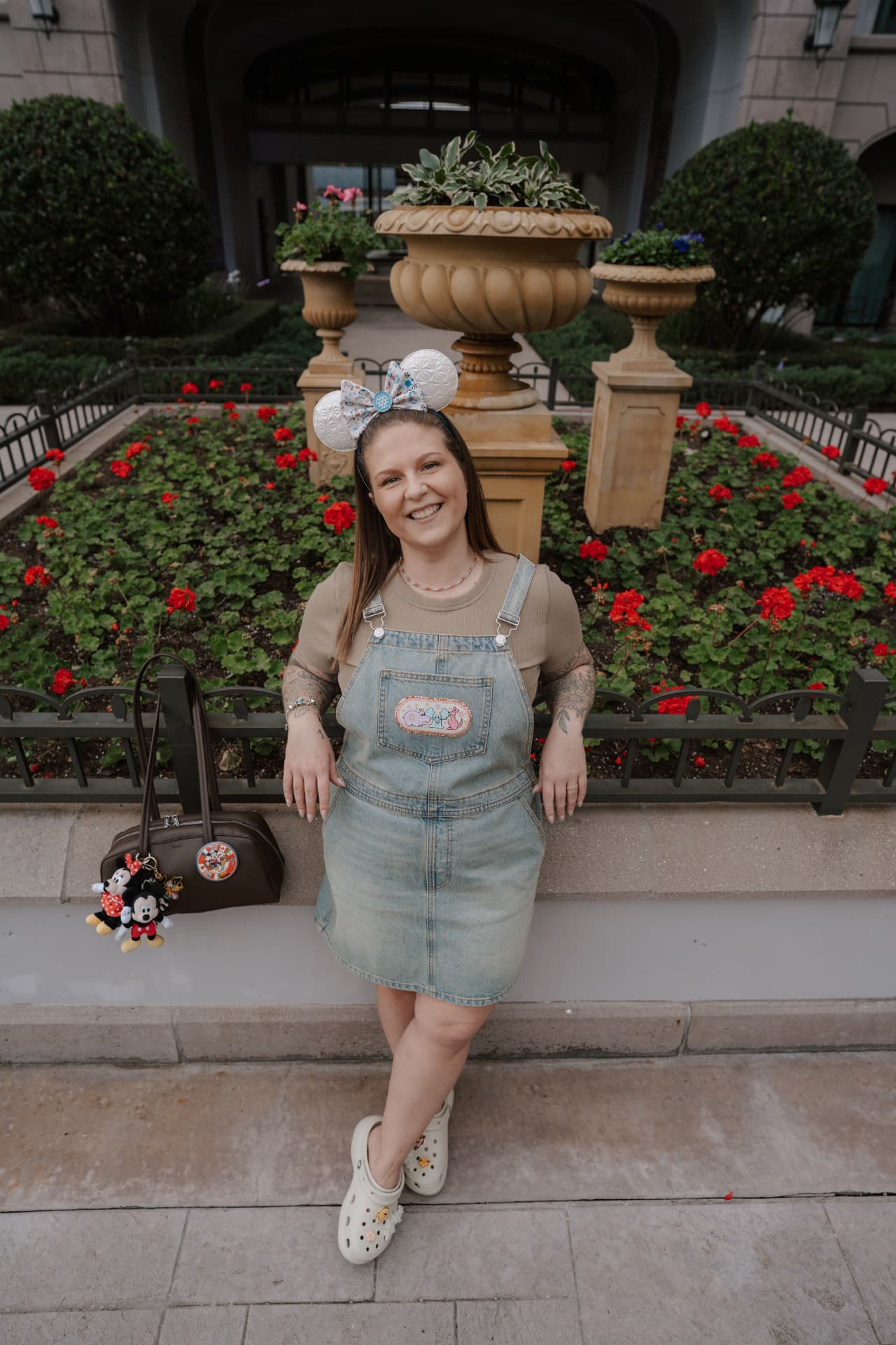 Jenna Caron seated among flowers at Epcot