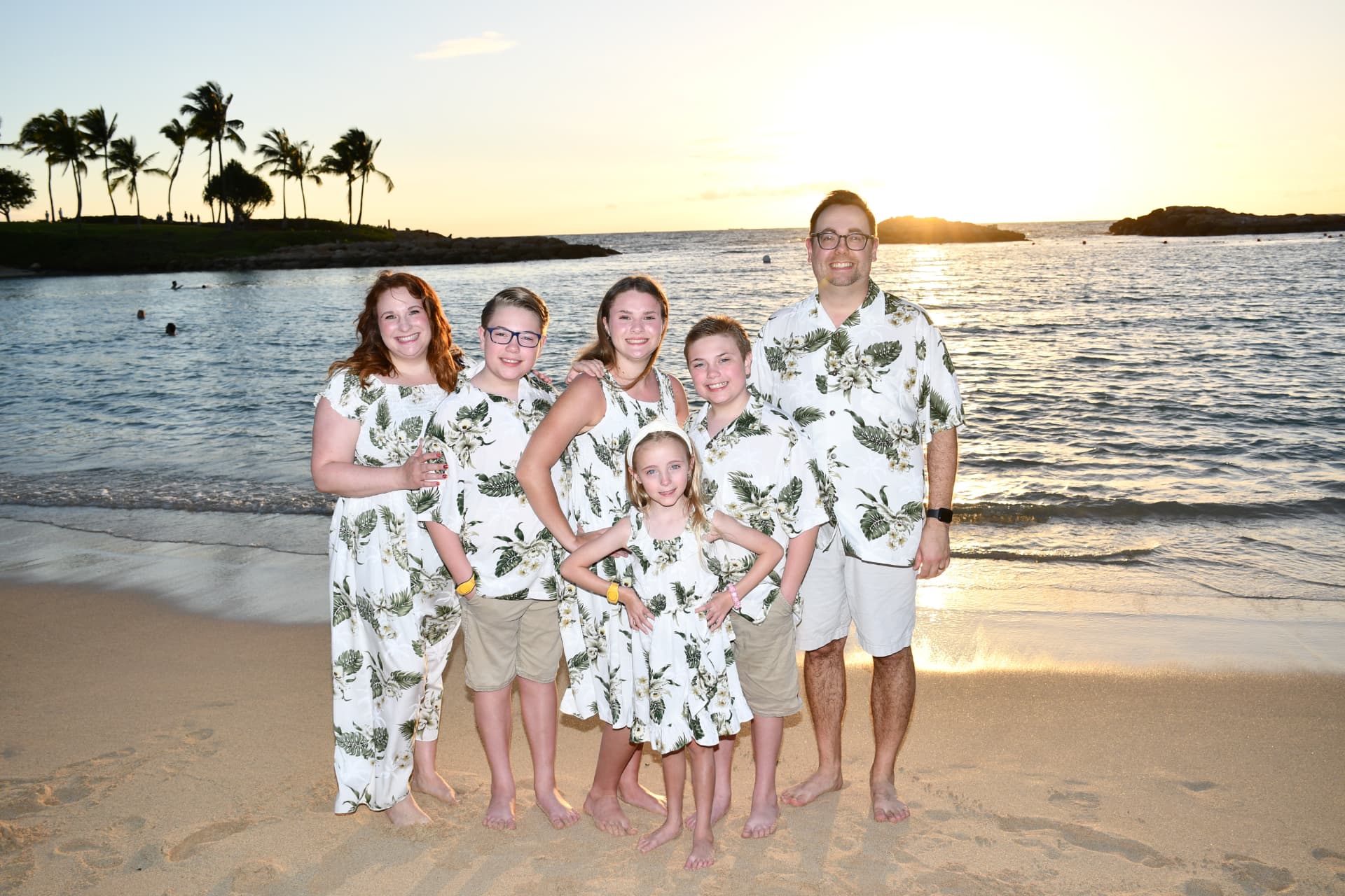 Jamie Thomas and her family on the beach at Aulani, A Disney Resort and Spa