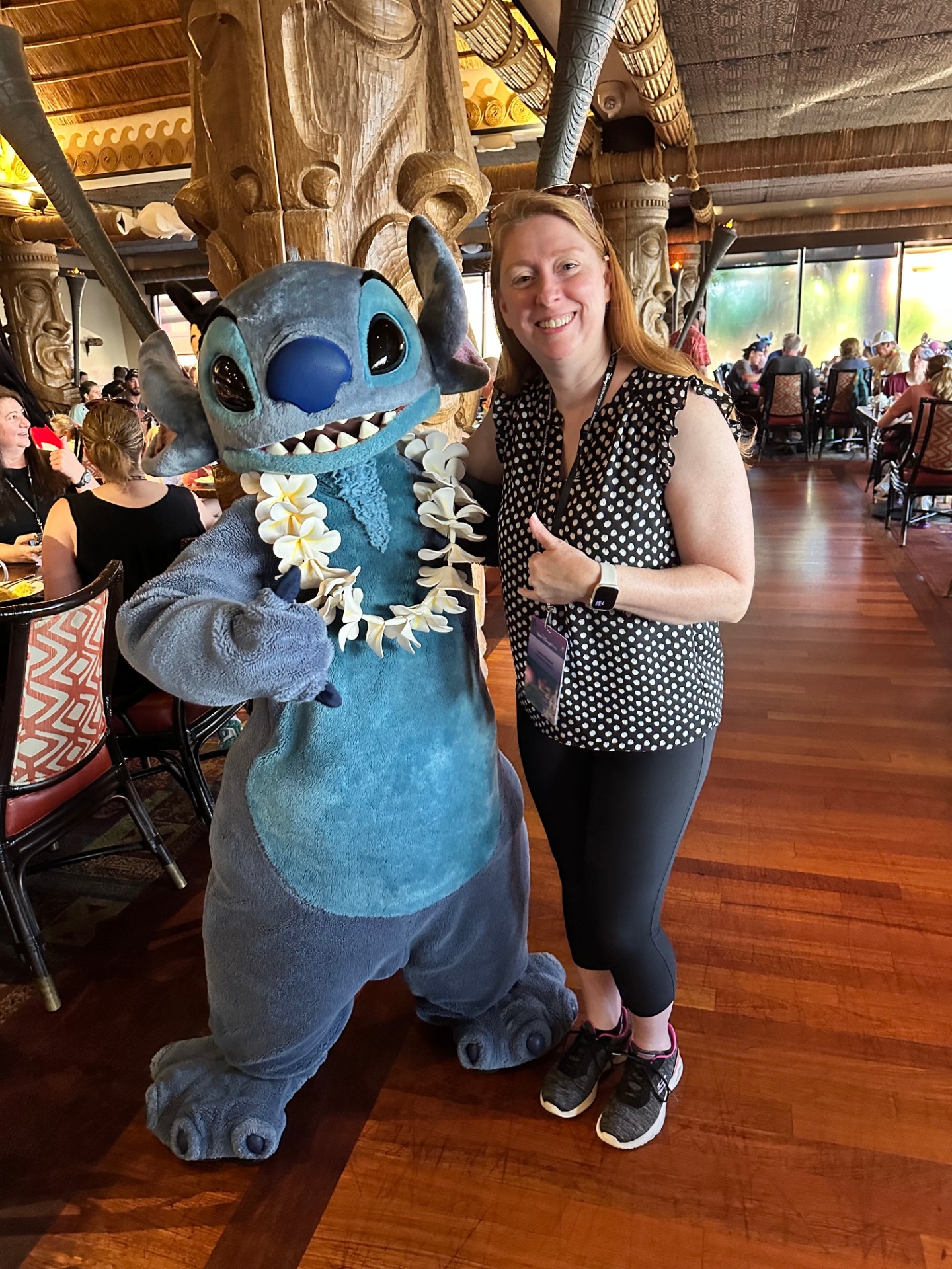 Laura giving a thumbs-up with Stitch at 'Ohana, Disney's Polynesian Village Resort