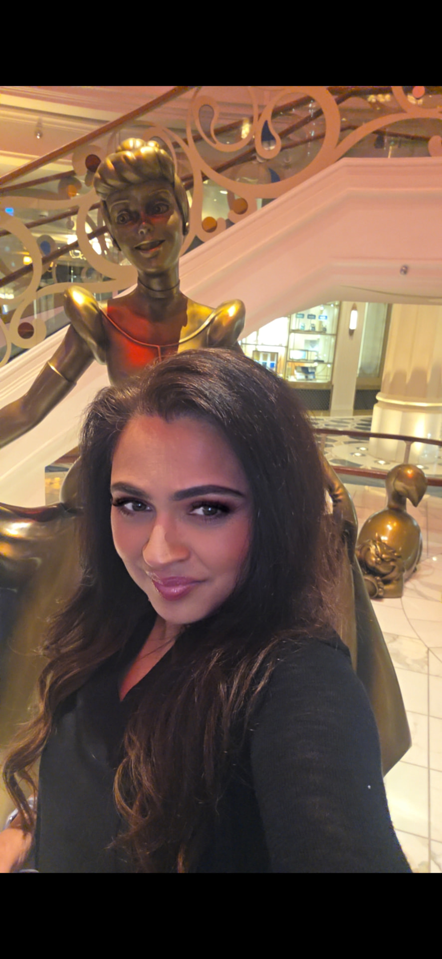Farya Zubair beside the Cinderella statue aboard the Disney Wish