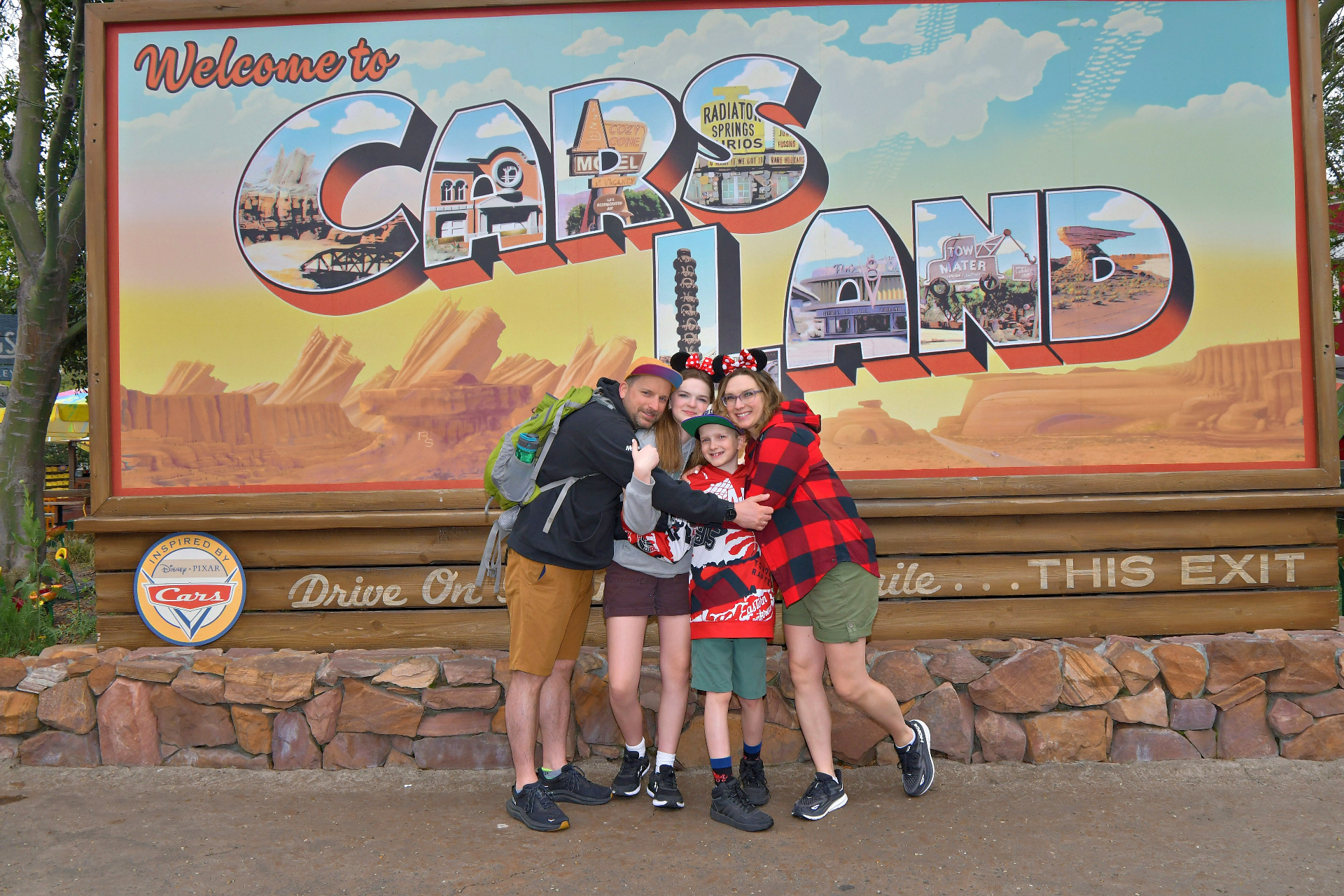 Krystal Moore and her family in front of the Cars Land sign at Disney California Adventure