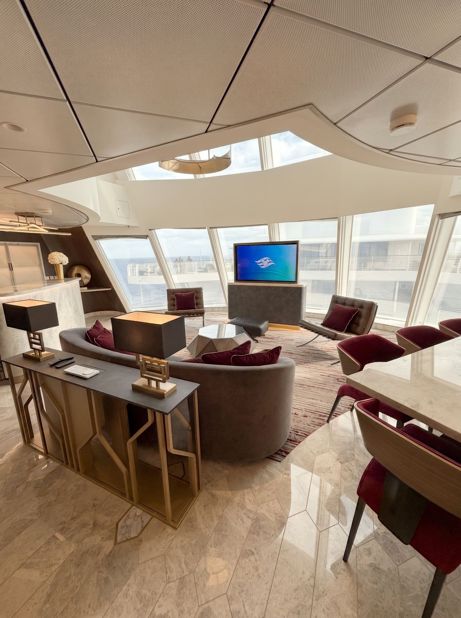 Luxury Disney Cruise Line Concierge stateroom lounge interior with elegant furnishings and ocean views