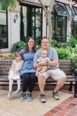 Kathryn and her family on a bench at Disney Springs