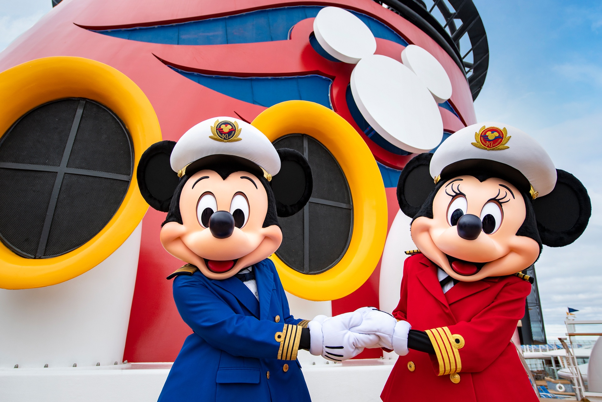 Disney Cruise Line ship at sunset with families on deck